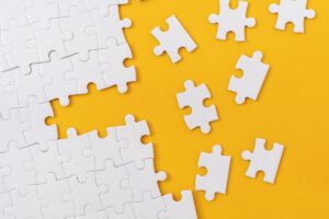 Partially complete jigsaw puzzle with scattered missing pieces