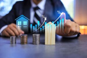 Real estate investment concept with person pointing on growth graph and coin stacking to get profit from property